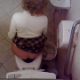 The daring pervert cameraman loses his cool when video recording this curly-haired blonde girl peeing & pooping on the toilet. Something spooks him, and he gets out of there fast, but we still hear some good plops.